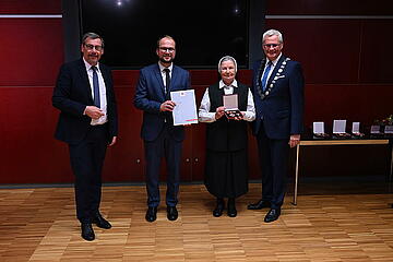 Bürgermeister Thomas Steiner, 1. Vizebürgermeister Istvan Deli und 2. Vizebürgermeister Otto Kropf zeichnen Sr. Consolata Supper mit dem Verdienstkreuz der Landeshauptstadt Freistadt Eisenstadt aus
